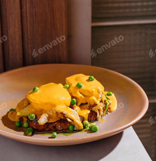 Preview: Delicious poached benedict eggs with hollandaise sauce served for brunch