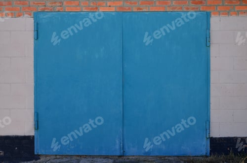 Preview: The texture of a painted metal gate from a brick garage