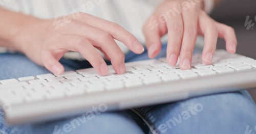 Preview: Woman typing on laptop computer