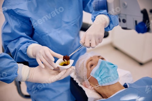 Preview: Close up of surgeon using iodine for sterilization in operating room at eye clinic.