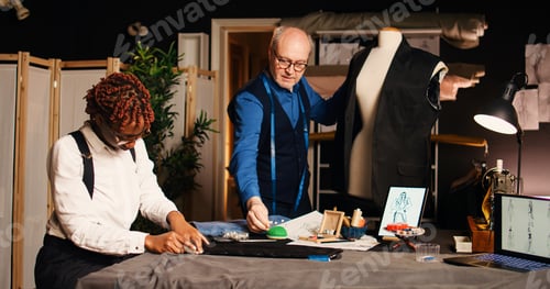 Preview: Tailors Working on Designs in Fashion Studio