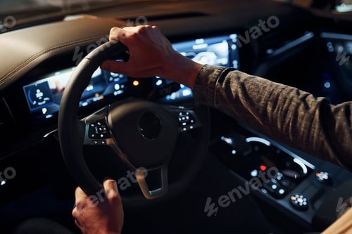 Preview: Handsome unshaved man in fashionable clothes riding his automobile