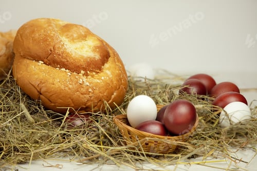 Preview: Brown and white eggs and bakery products on hay on white background