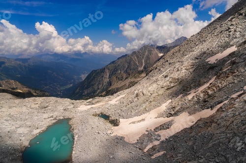 Preview: Turquoise mountain lake with snow patches in alpine rocky landscape