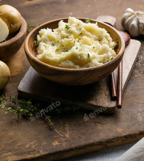 Preview: Mushed potatoes top view with raw potatoes and spices