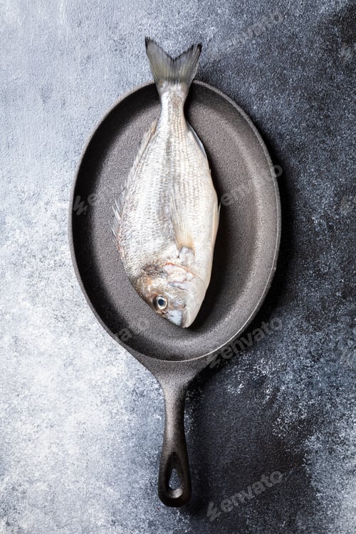 Preview: Fresh uncooked Dorado or sea bream fish in the pan