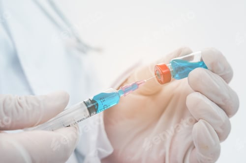 Preview: Doctor with syringe ready for injection of vaccine to patient. Vaccination concept.