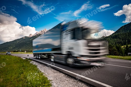 Preview: Fuel truck rushes down the highway in the background the Alps. Truck Car in motion blur.