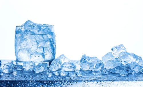 Preview: Water with crushed ice cubes in glass isolated on white background
