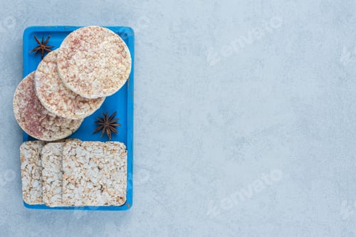 Preview: Some rice cake and cinnamon on the board, on the marble background