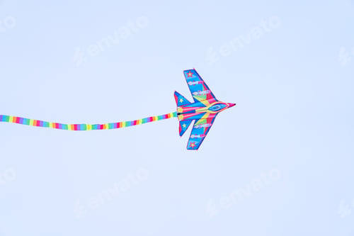 Preview: A color kite flying against a blue sky.