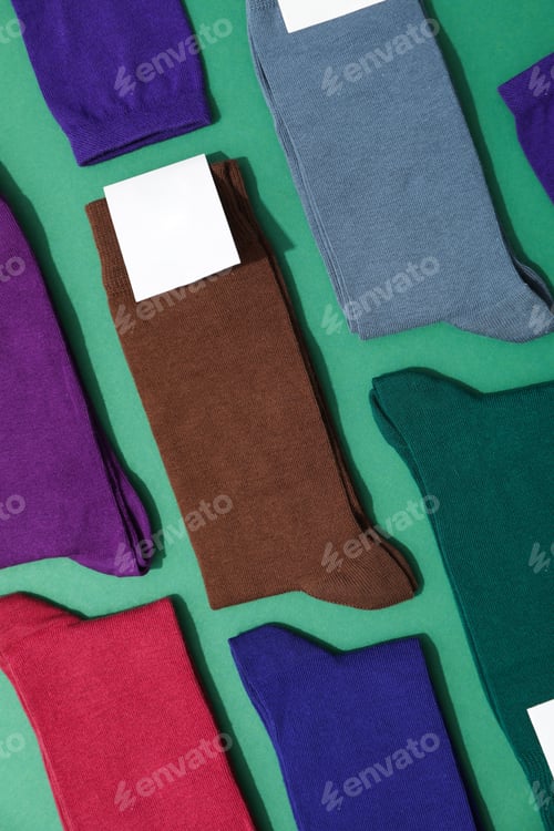 Preview: Socks with blank label on green background, space for text