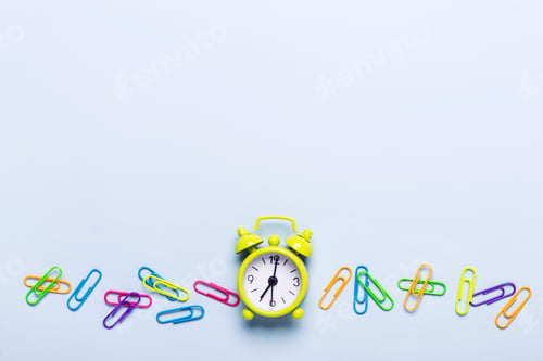 Preview: School supplies and alarm clock on a blue background