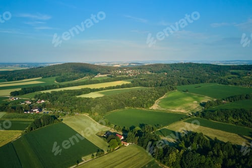 Preview: Aerial view of countryside area with village and mountains