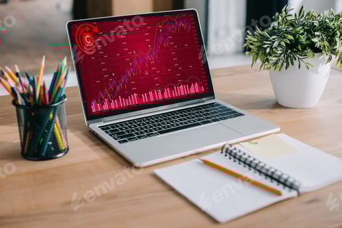 Preview: laptop with red business graph standing at workspace