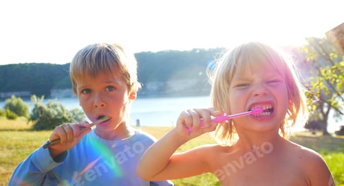 Preview: Smiling Children Brushing Teeth Outdoors in Natural Light