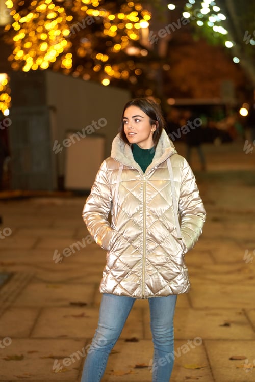 Preview: Woman in winter coat standing outdoors.