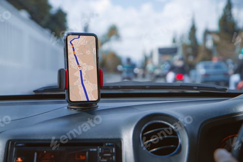 Preview: Smartphone with navigation route on screen mounted on phone holder at car dashboard