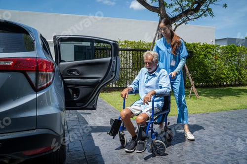 Preview: Nurse takes care of a disabled senior man in a wheelchair into a car.