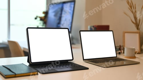 Preview: Mock up laptop and tablet computer on white office desk. White display for web design promotion.