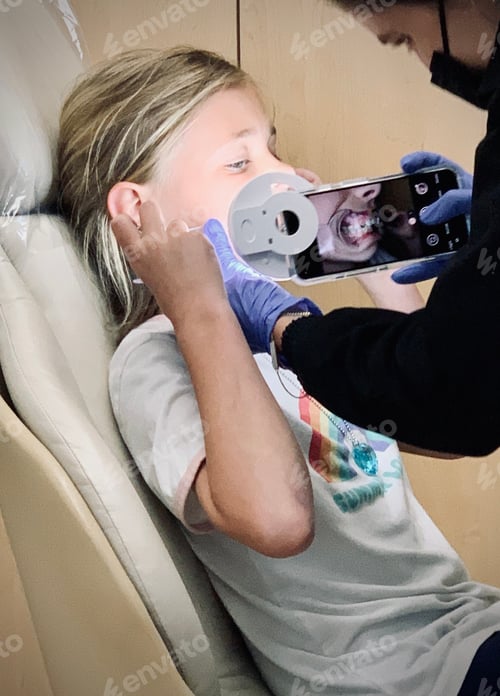 Preview: Child Receives Dental Checkup at Dentist Office