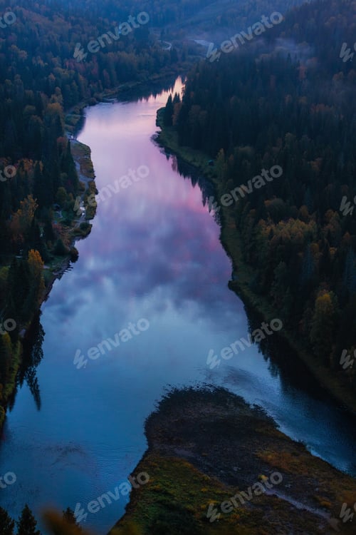 Preview: Sunset reflects on the river surrounded by trees in a valley