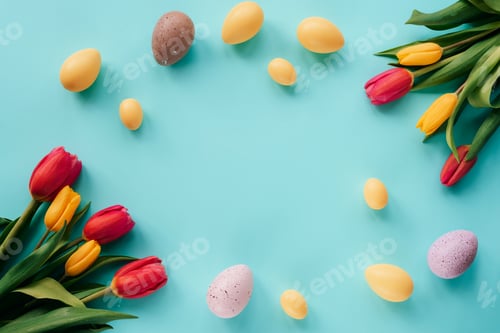 Preview: Happy Easter concept. Festive blue background with decorated eggs and colorful tulips. Top view