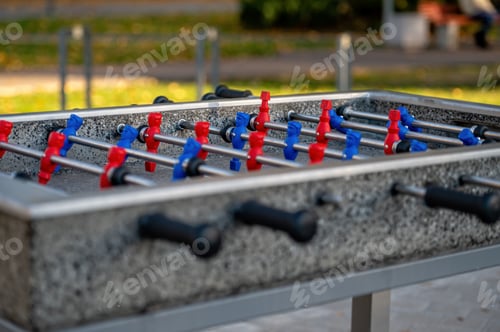 Preview: outdoor football table to play football with red and blue players, close up