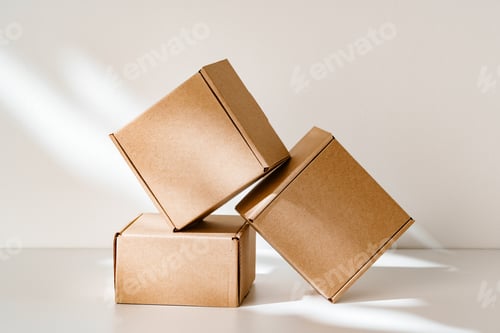 Preview: Freshly packed cardboard boxes resting on a white surface, illuminated by soft natural light