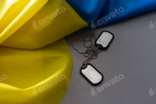 Preview: Army identification badges, ribbons of the Ukrainian flag, scattered machine-gun cartridges and live