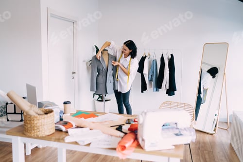 Preview: Female tailor working with jacket in atelier
