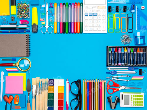 Preview: Office supplies and tools arranged on a bright blue desk at a creative workspace