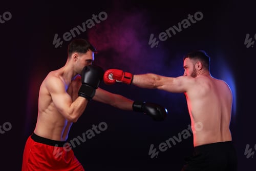 Preview: Men in boxing gloves fighting on dark background with smoke