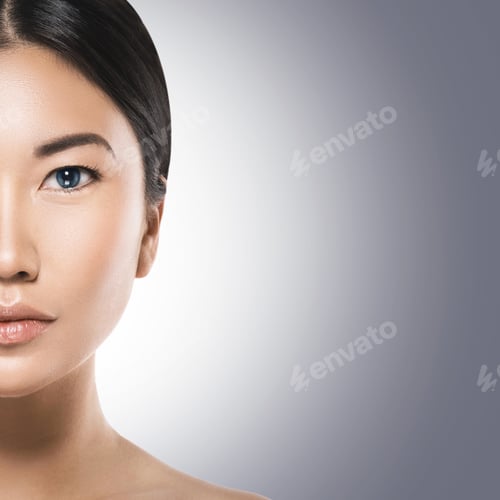 Preview: Half of asian woman face on gray background