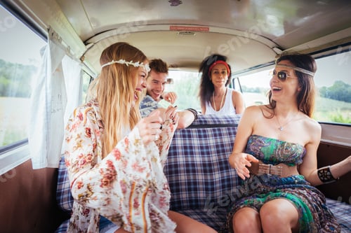 Preview: Happy friends driving a vintage minivan