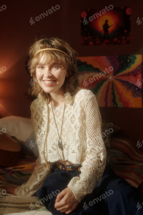 Preview: Smiling Woman Sitting on Bed with Colorful Paintings
