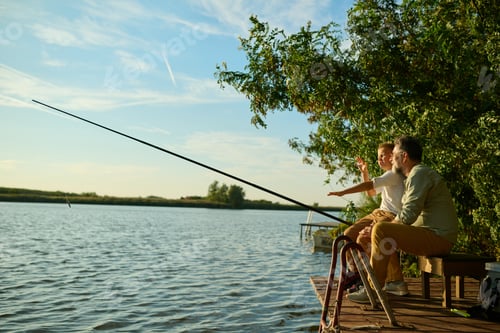 Preview: Grandfather and grandson enjoying a relaxing day fishing on a wooden dock