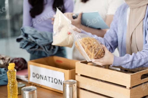 Preview: Diverse group of individuals organizing donations, sorting food and clothing