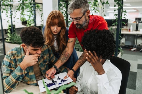 Preview: A casual interracial team looking at statistics while working at enterprise.