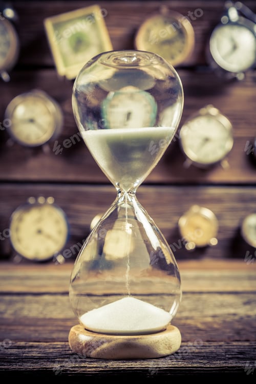 Preview: Old hourglass with flowing sand