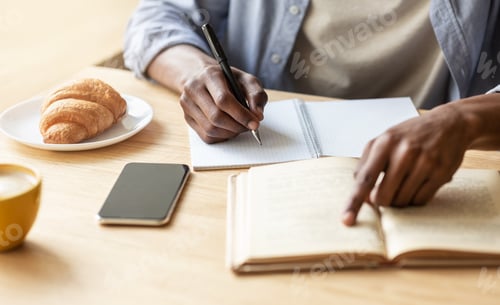 Preview: Unrecognizable black guy getting ready for exam in cafe, closeup of hands