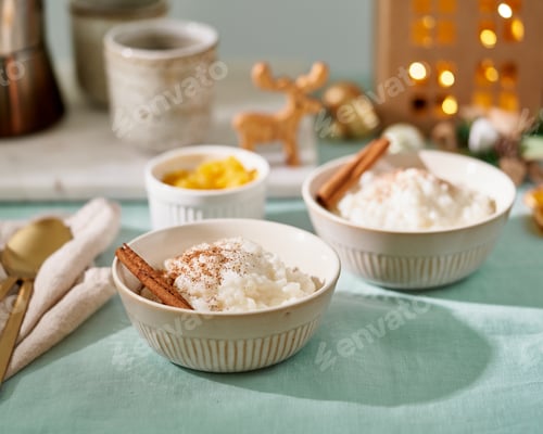 Preview: Rice pudding. French milk dessert. Christmas evening or night with cozy light of lamp at dark home