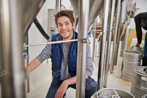 Preview: Your lager is on its way. Portrait of a man working in a microbrewery.