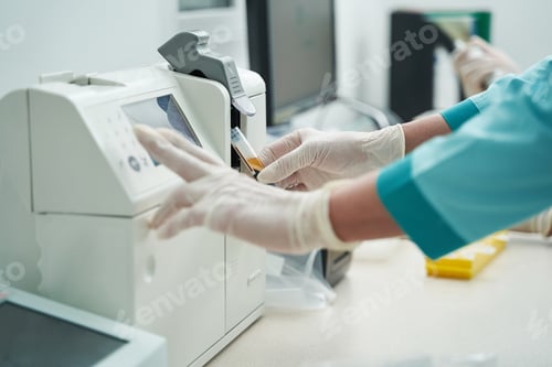 Preview: Female laborant doing blood tests with modern equipment