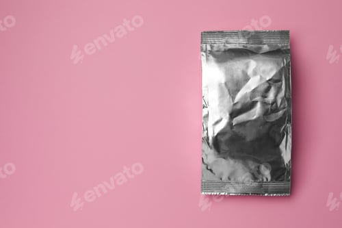 Preview: Blank foil package on pink background, top view. Space for text