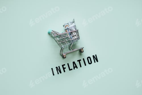 Preview: Shopping basket cart with dollars cash and word Inflation on blue background.