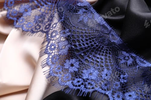 Preview: Beautiful blue lace on color fabrics, closeup