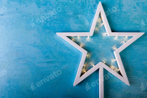 Preview: White Christmas star with yellow lights on blue background