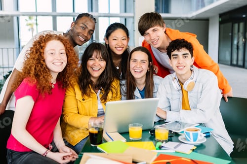Preview: International group of young college students smiling at camera sitting together