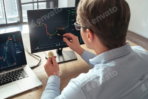 Preview: Business trader investor holding gold bitcoin buying or selling cryptocurrency tokens online on pc